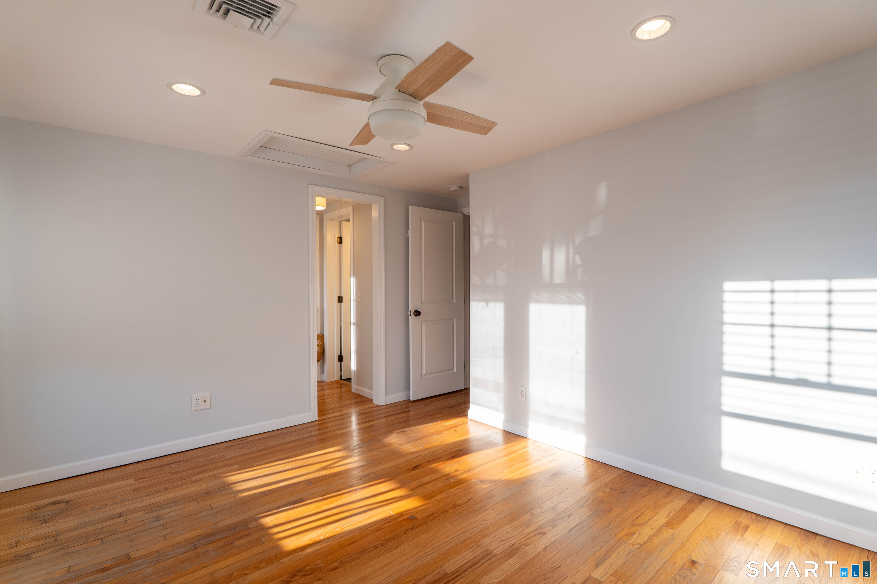 19 Elaine Road Milford, CT 06460 - Photo 18 of 24 an empty room with wooden floor and windows