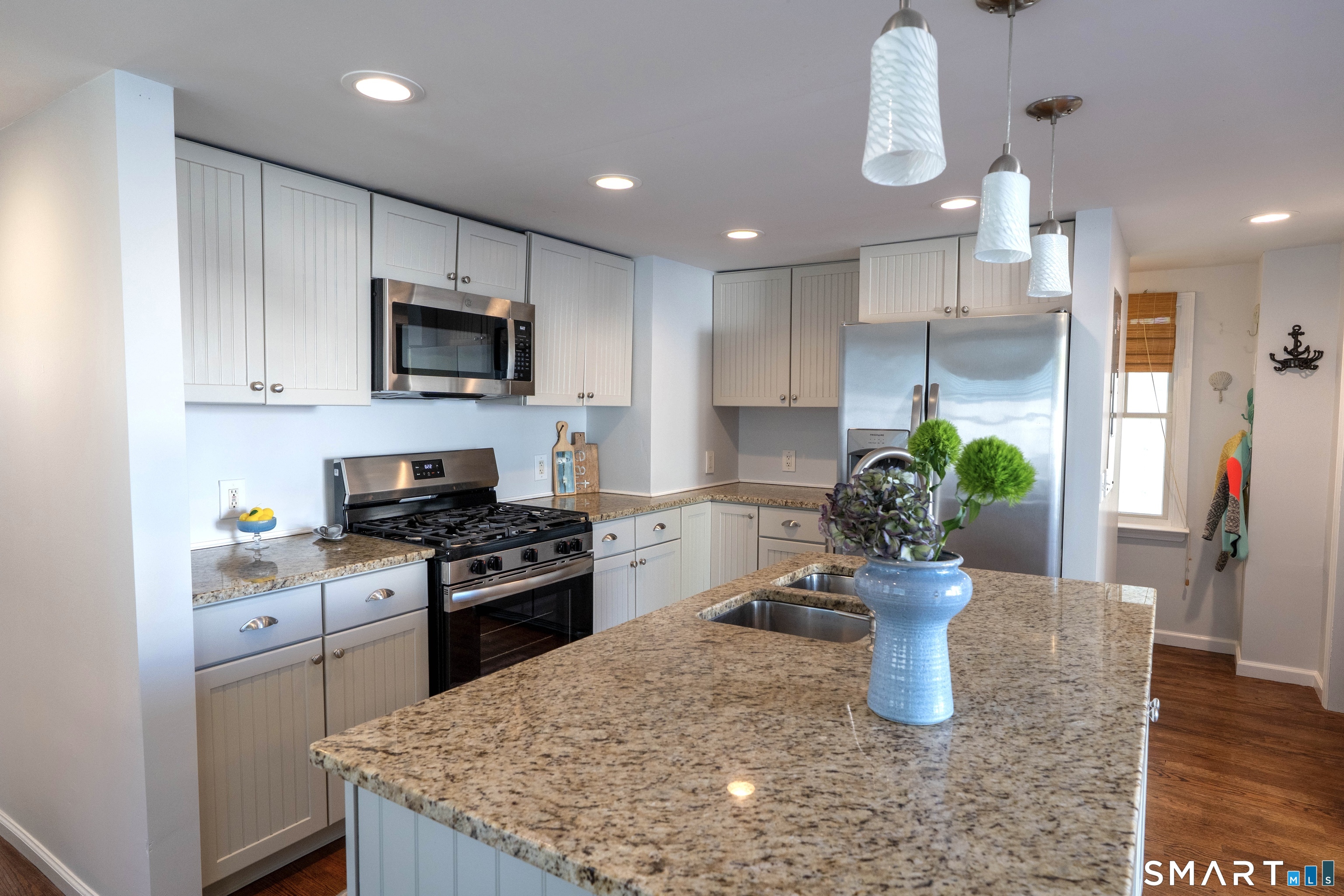 19 Elaine Road Milford, CT 06460 - Photo 7 of 24 a kitchen with a sink a stove and cabinets