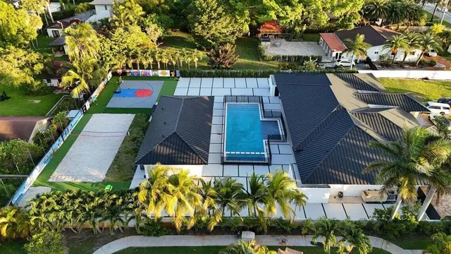 an aerial view of residential houses with yard