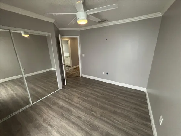 a bathroom with a granite countertop sink toilet a mirror a vanity and shower