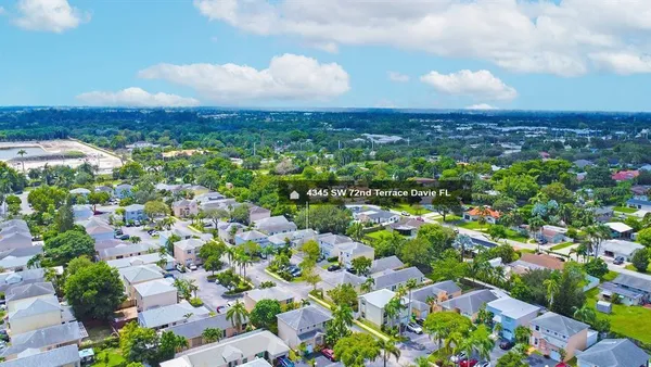 an aerial view of a house with a yard basket ball court and outdoor seating