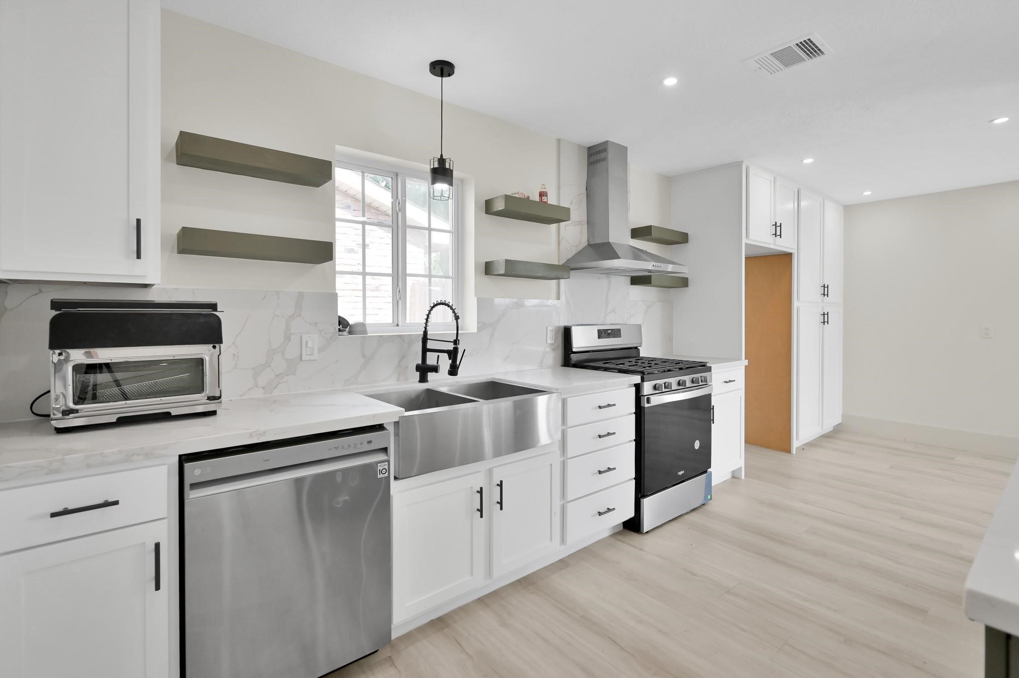 6026 Willowbend Boulevard Houston, TX 77096 - Photo 13 of 46 a kitchen with stainless steel appliances white cabinets and a sink