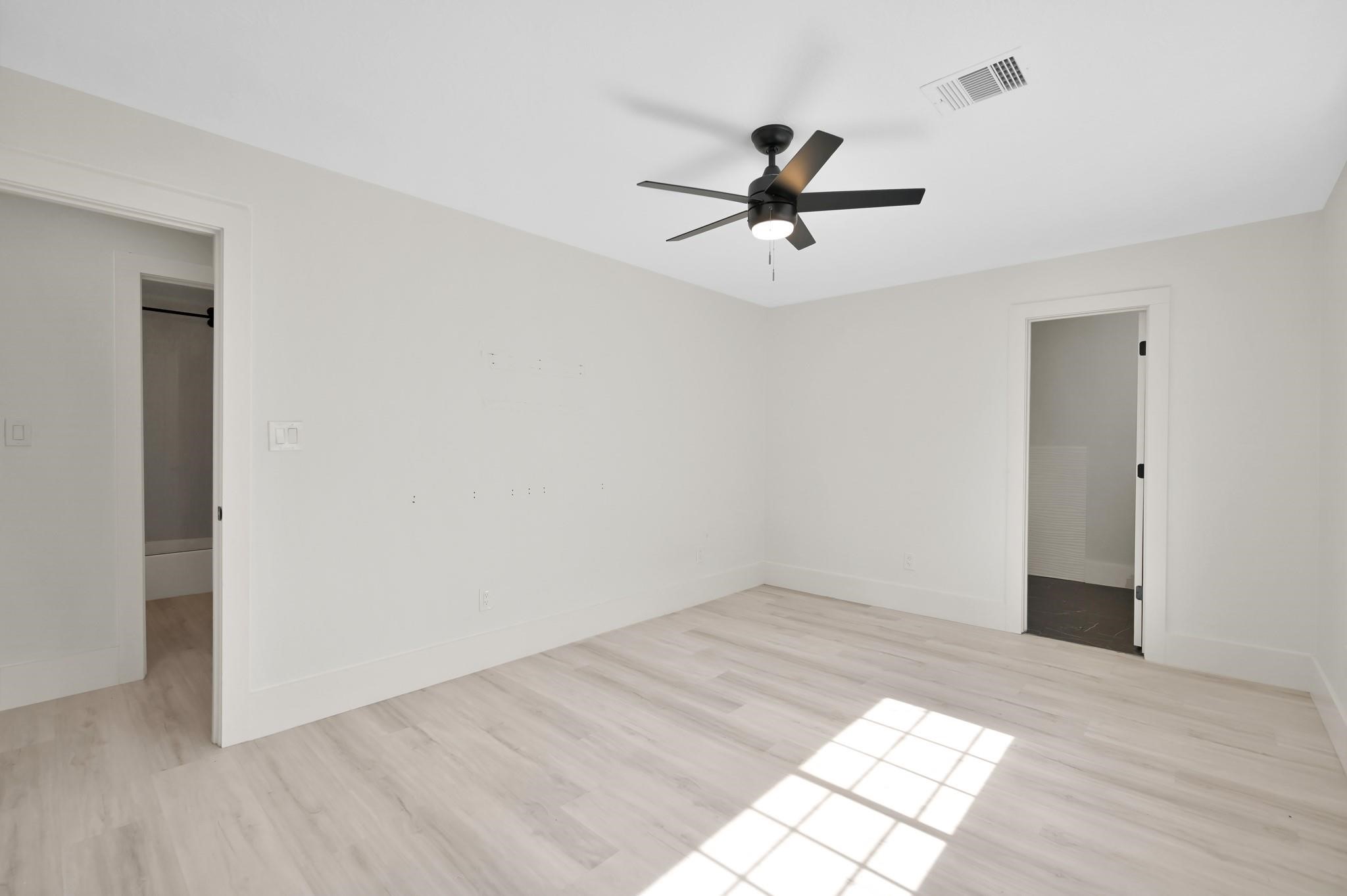 6026 Willowbend Boulevard Houston, TX 77096 - Photo 25 of 46 a view of a big room with wooden floor closet and windows