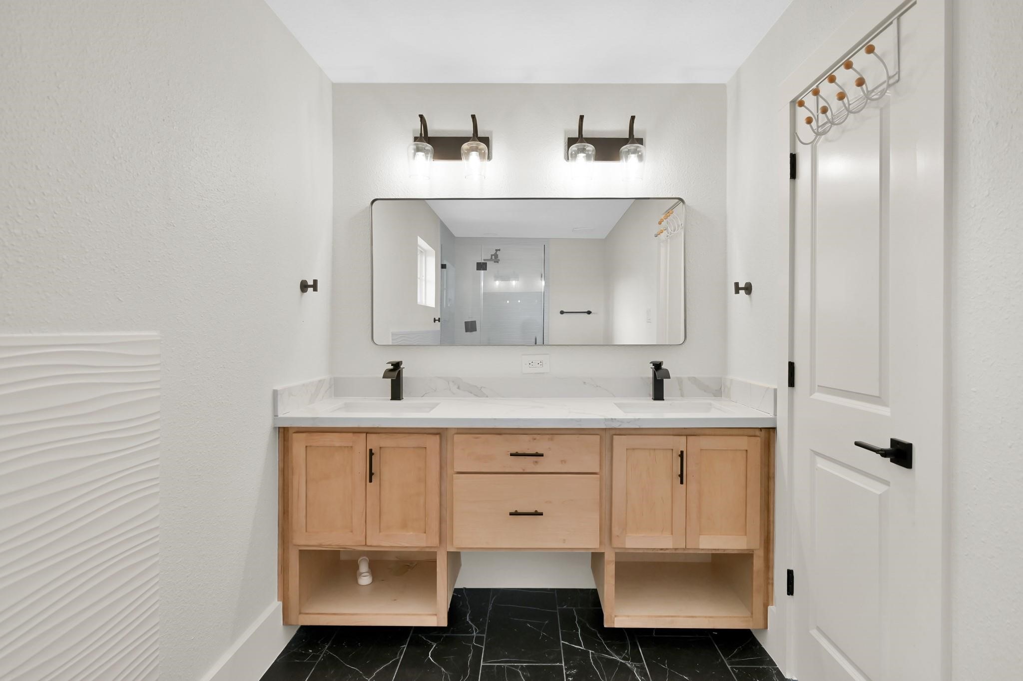 6026 Willowbend Boulevard Houston, TX 77096 - Photo 27 of 46 a spacious bathroom with a sink and a mirror