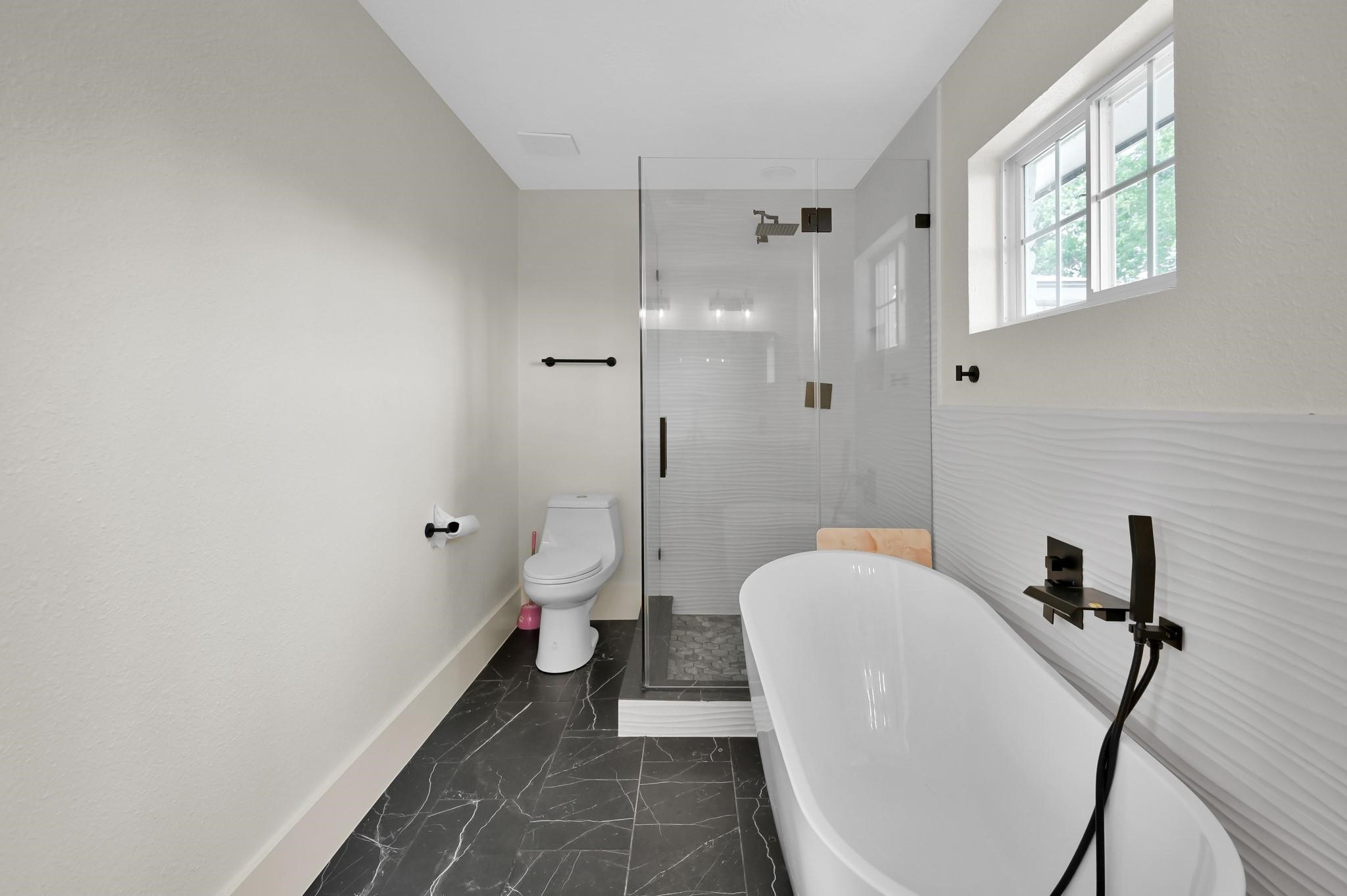 6026 Willowbend Boulevard Houston, TX 77096 - Photo 29 of 46 a bathroom with a toilet and a shower