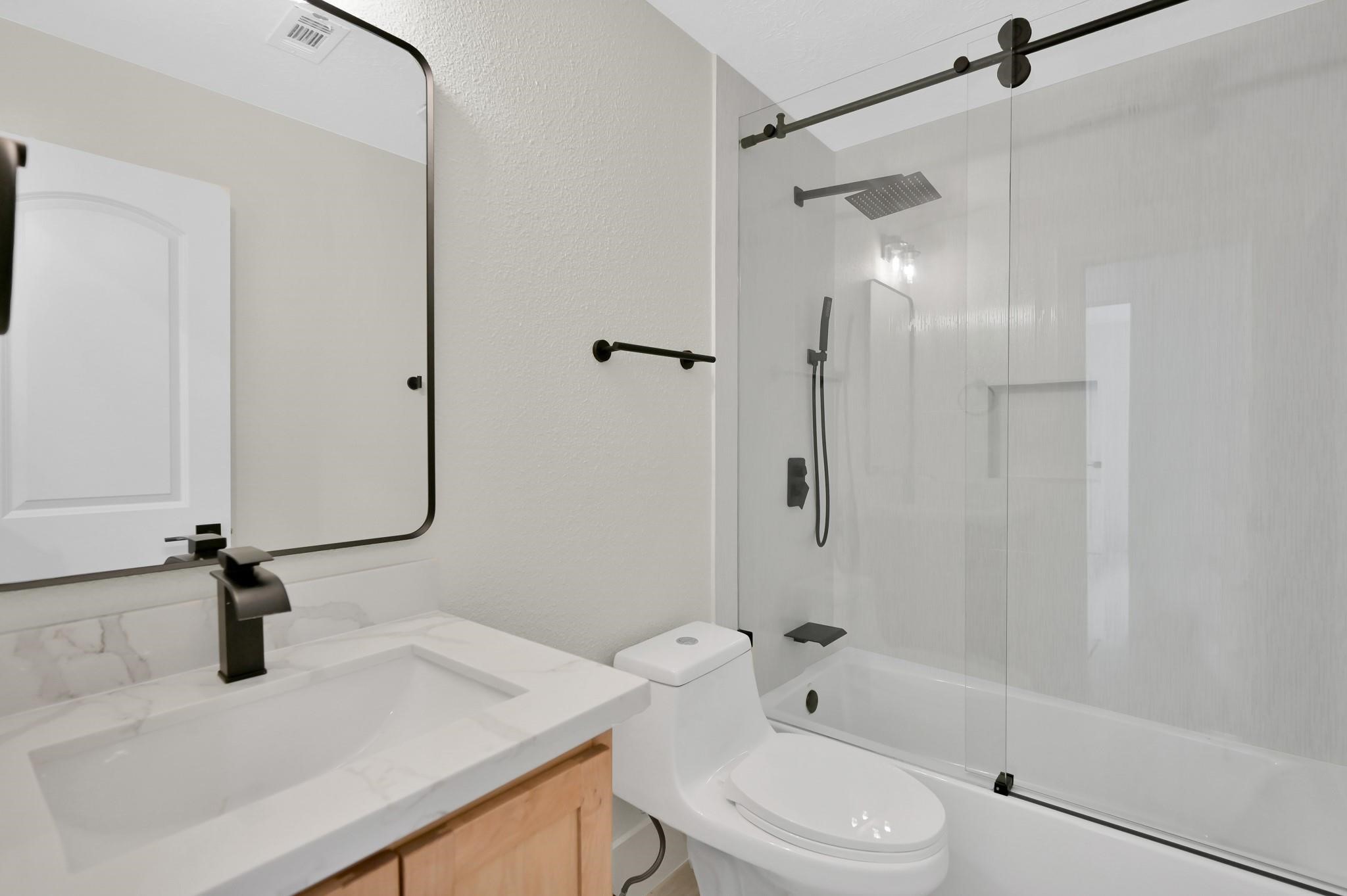 6026 Willowbend Boulevard Houston, TX 77096 - Photo 35 of 46 a bathroom with a sink a toilet and shower