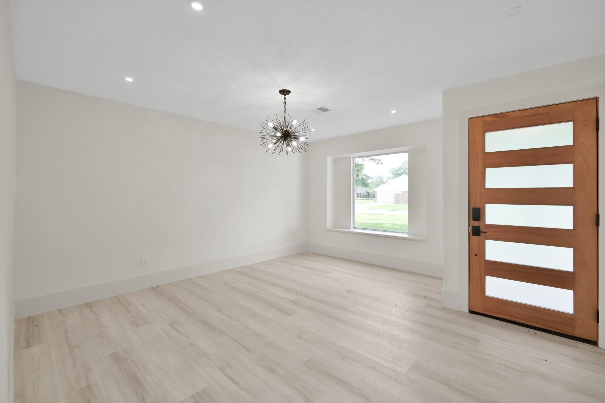 6026 Willowbend Boulevard Houston, TX 77096 - Photo 4 of 46 wooden floor in an empty room with a window