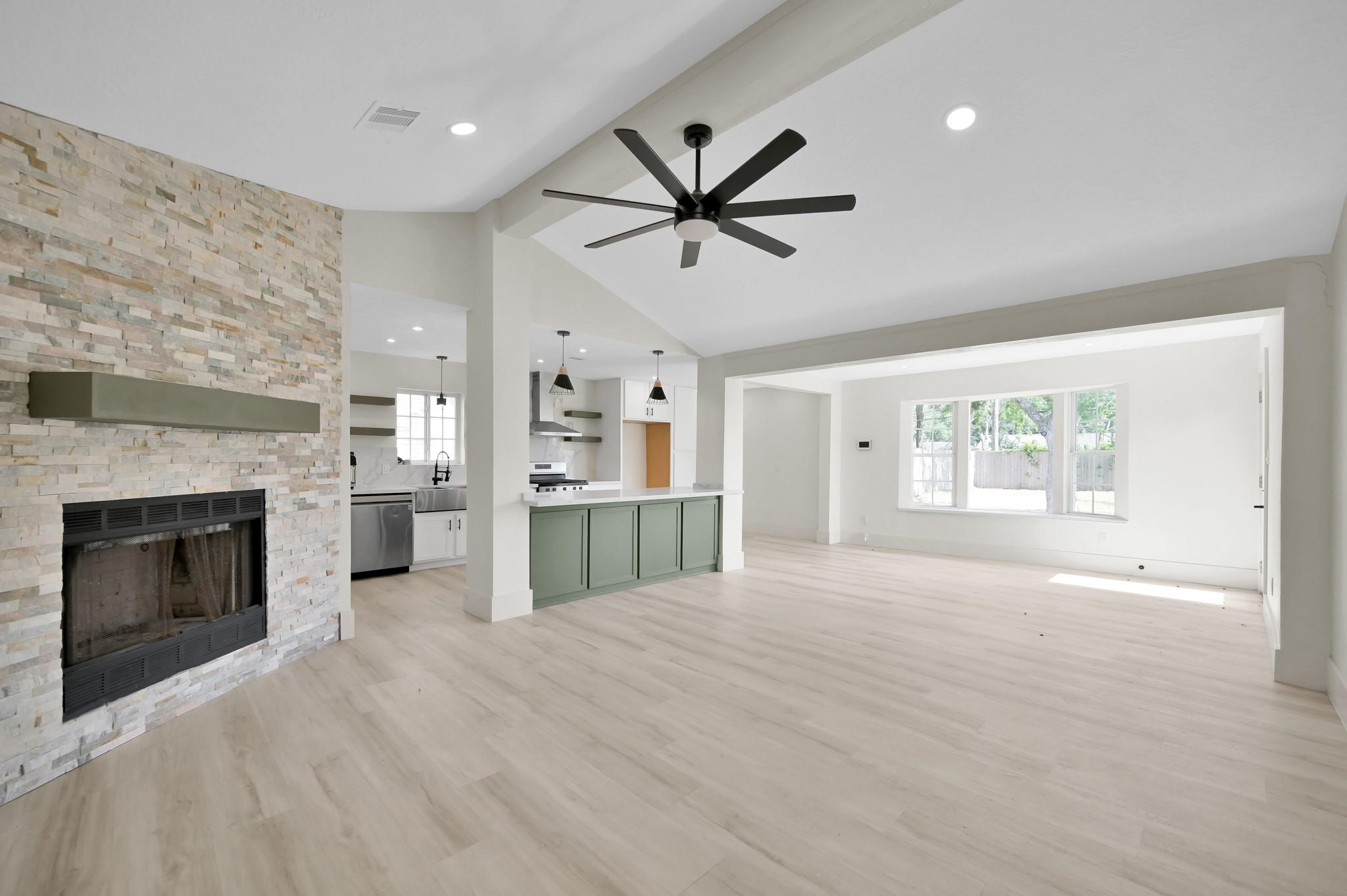 6026 Willowbend Boulevard Houston, TX 77096 - Photo 7 of 46 a view of an empty room with a fireplace and a window