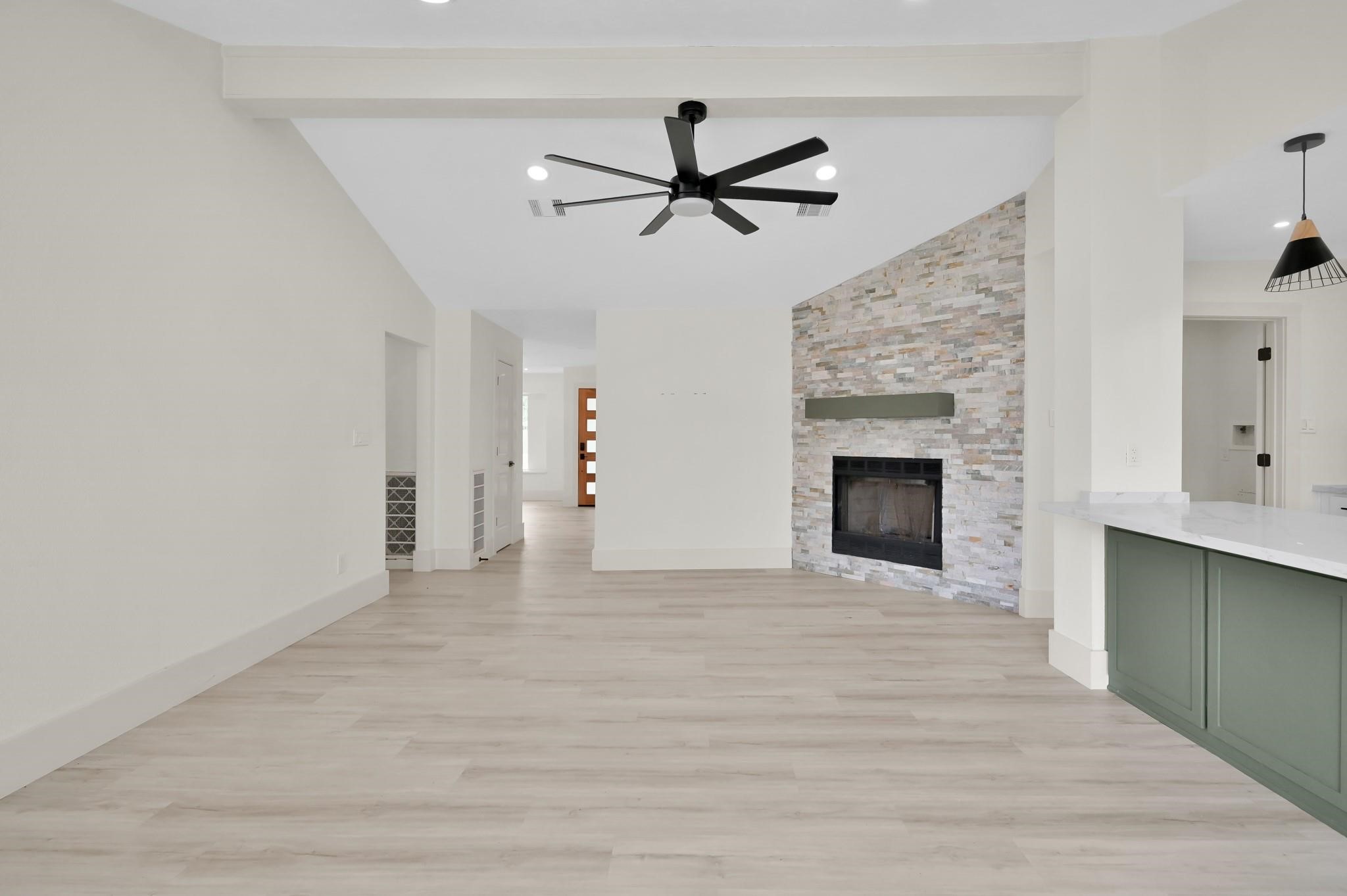 6026 Willowbend Boulevard Houston, TX 77096 - Photo 9 of 46 a view of empty room with a ceiling fan and a fireplace