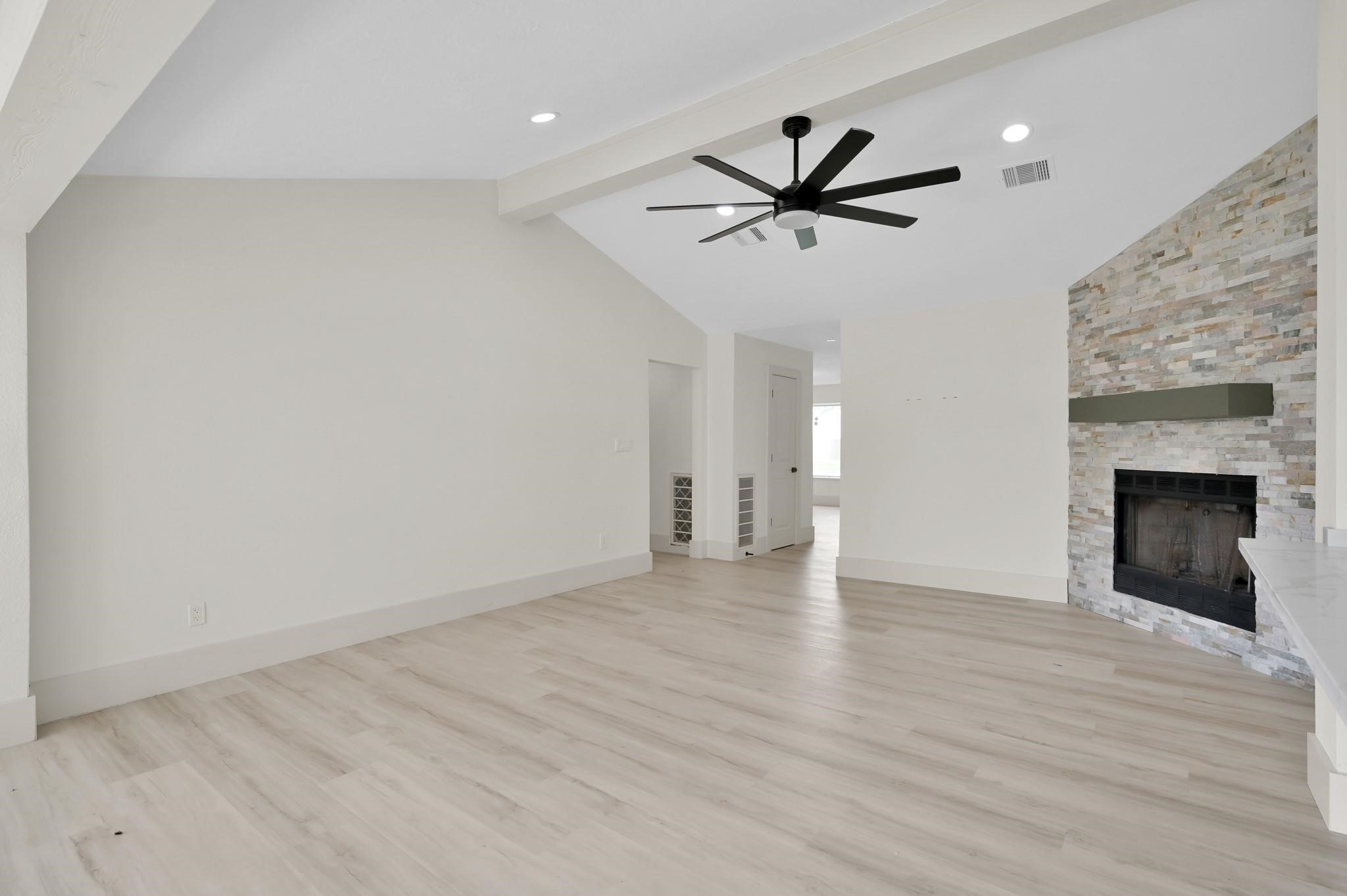 6026 Willowbend Boulevard Houston, TX 77096 - Photo 10 of 46 a view of empty room with wooden floor and fireplace