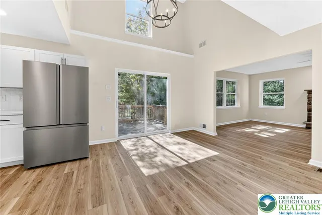 a view of a kitchen with furniture and refrigerator