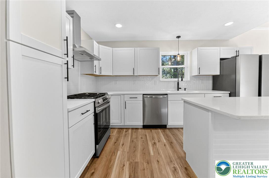 45 Coach Road Stroudsburg, PA 18360 - Photo 14 of 44 a kitchen with a sink a refrigerator and white cabinets