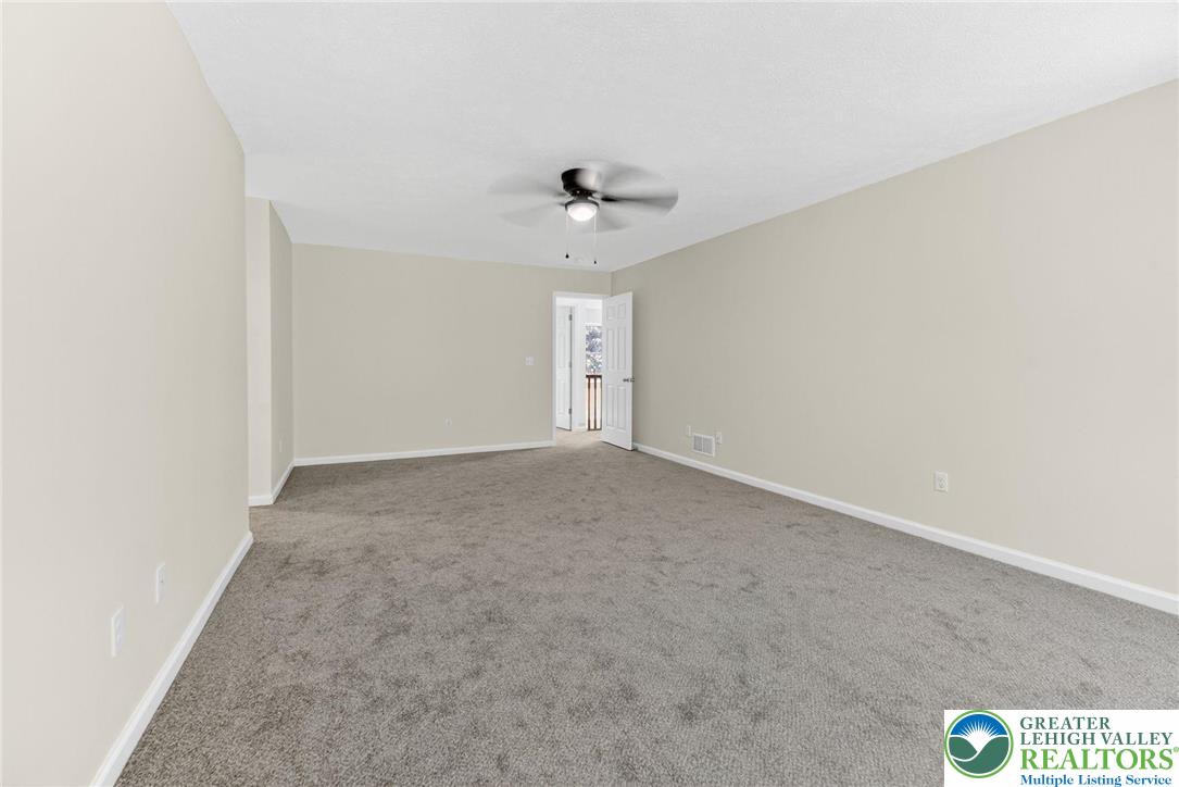 45 Coach Road Stroudsburg, PA 18360 - Photo 23 of 44 an empty room with a window and a ceiling fan