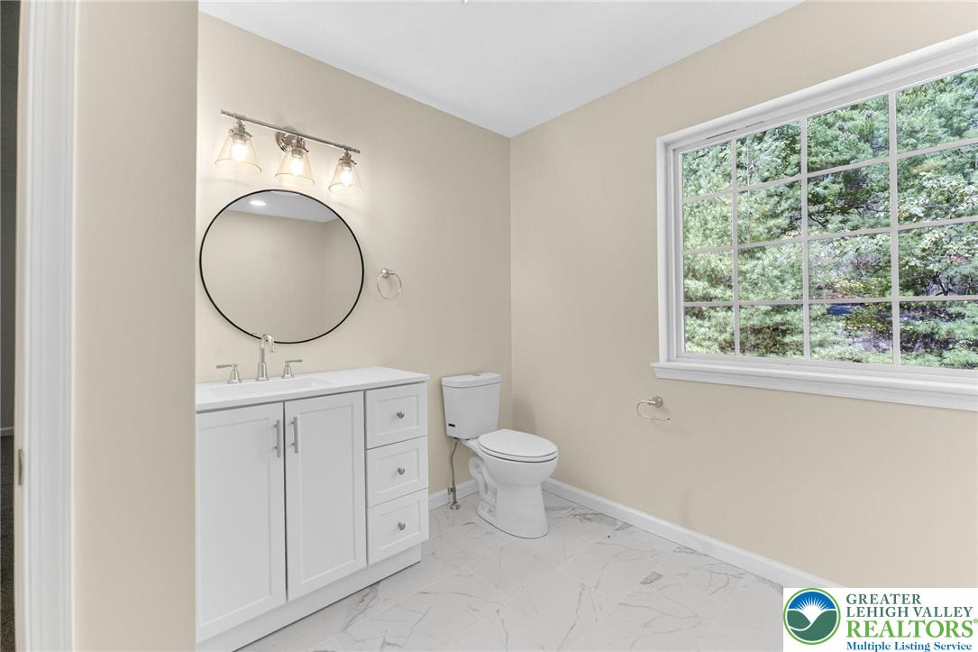 45 Coach Road Stroudsburg, PA 18360 - Photo 26 of 44 a bathroom with a toilet a sink and a window