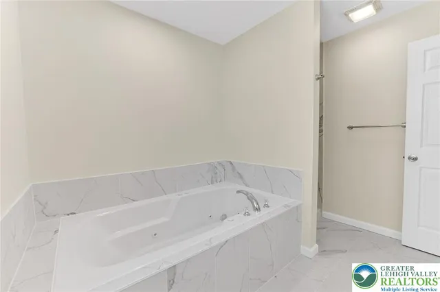 a white bath tub sitting in a bathroom