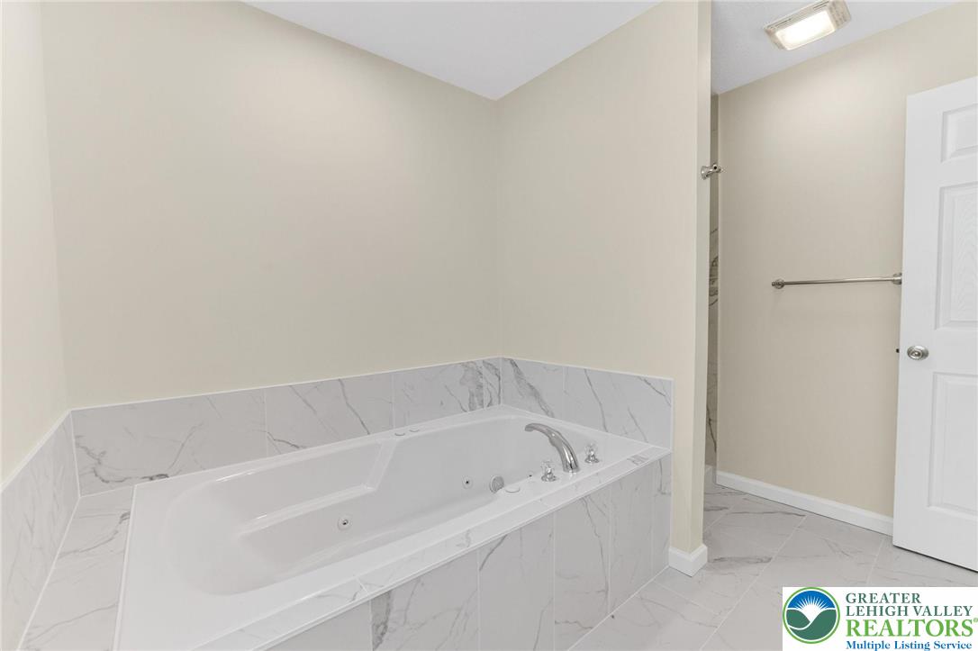 45 Coach Road Stroudsburg, PA 18360 - Photo 27 of 44 a white bath tub sitting in a bathroom