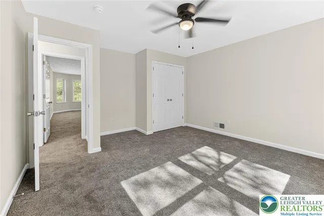 an empty room with a view of bathroom