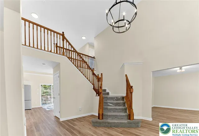 a view of staircase with white walls and a window