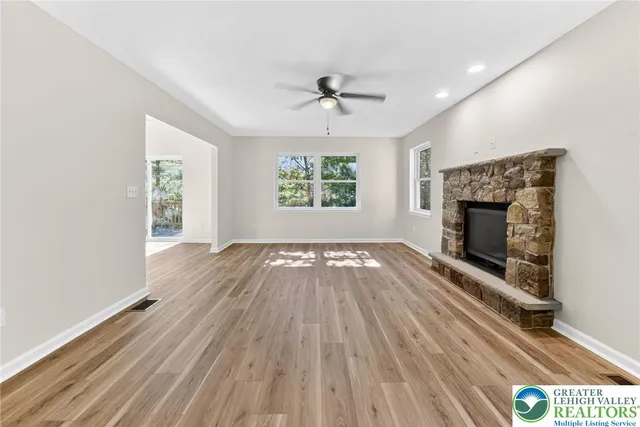 wooden floor in an empty room with a fireplace