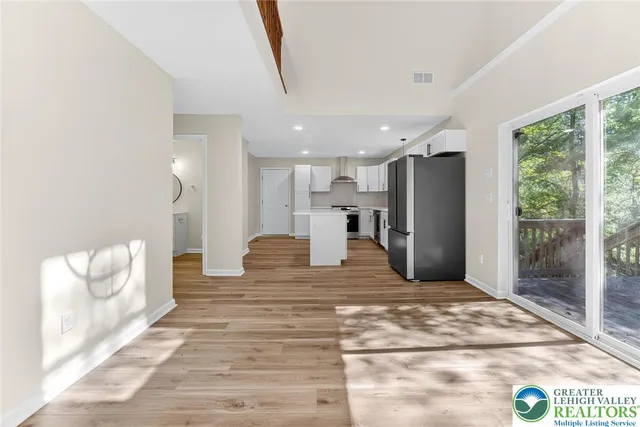 a view of kitchen with furniture and refrigerator