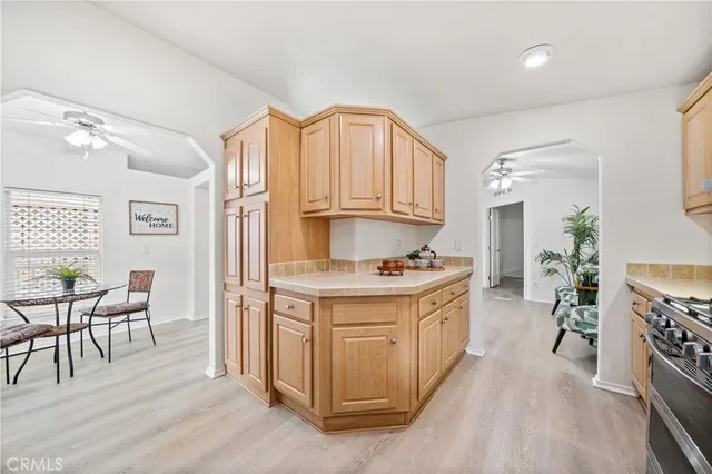 a kitchen with granite countertop a stove a sink and a refrigerator