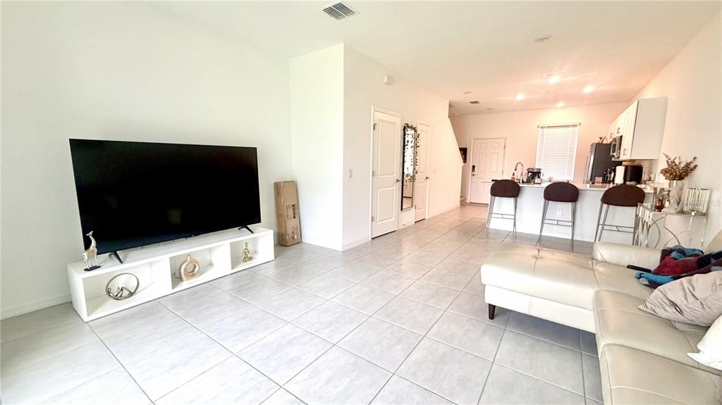 3244 Skyline Loop Kissimmee, FL 34758 - Photo 8 of 13 a living room with furniture and a flat screen tv