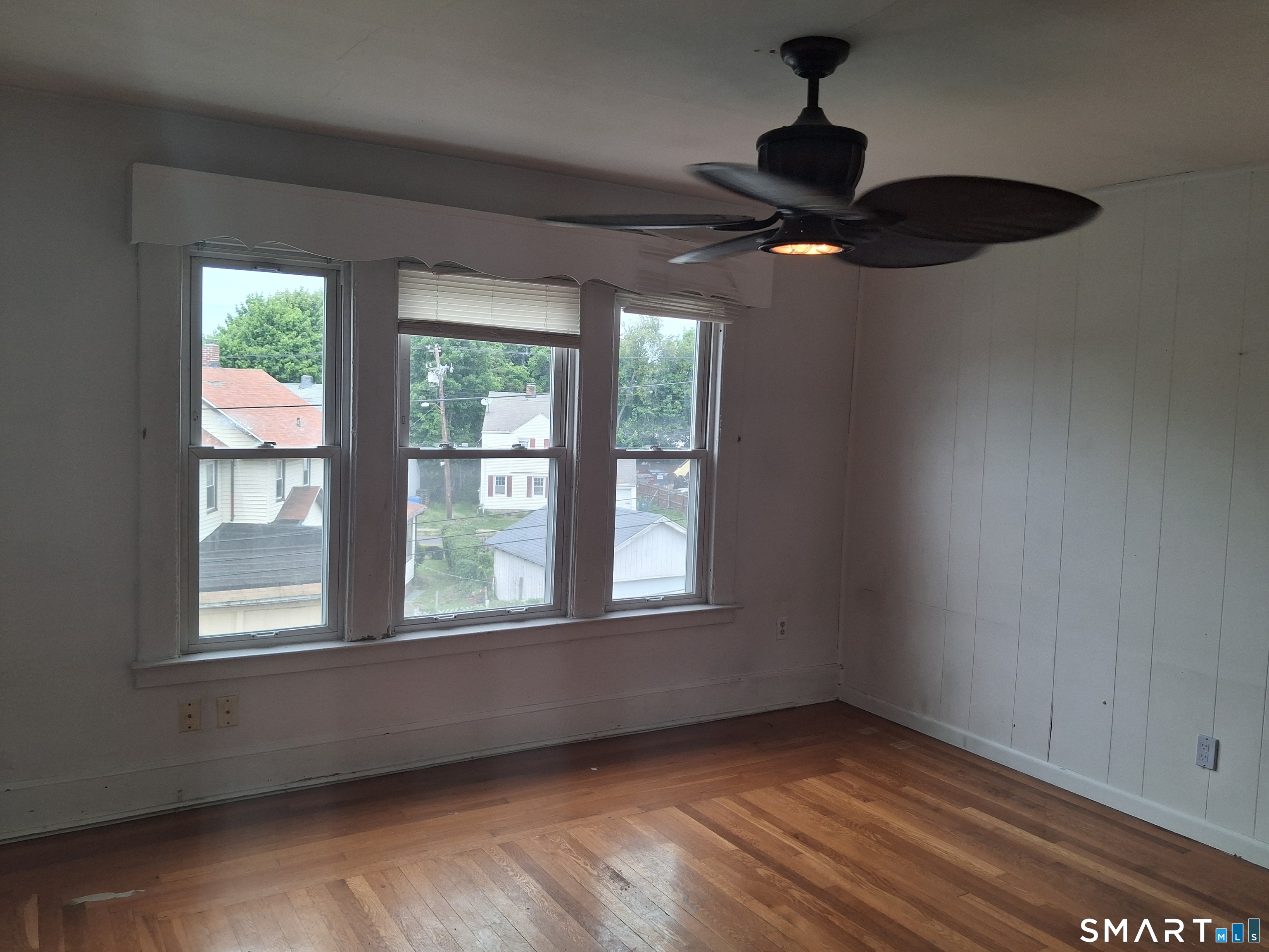 26 4th Street Hamden, CT 06514 - Photo 34 of 40 a view of an empty room with wooden floor and a window