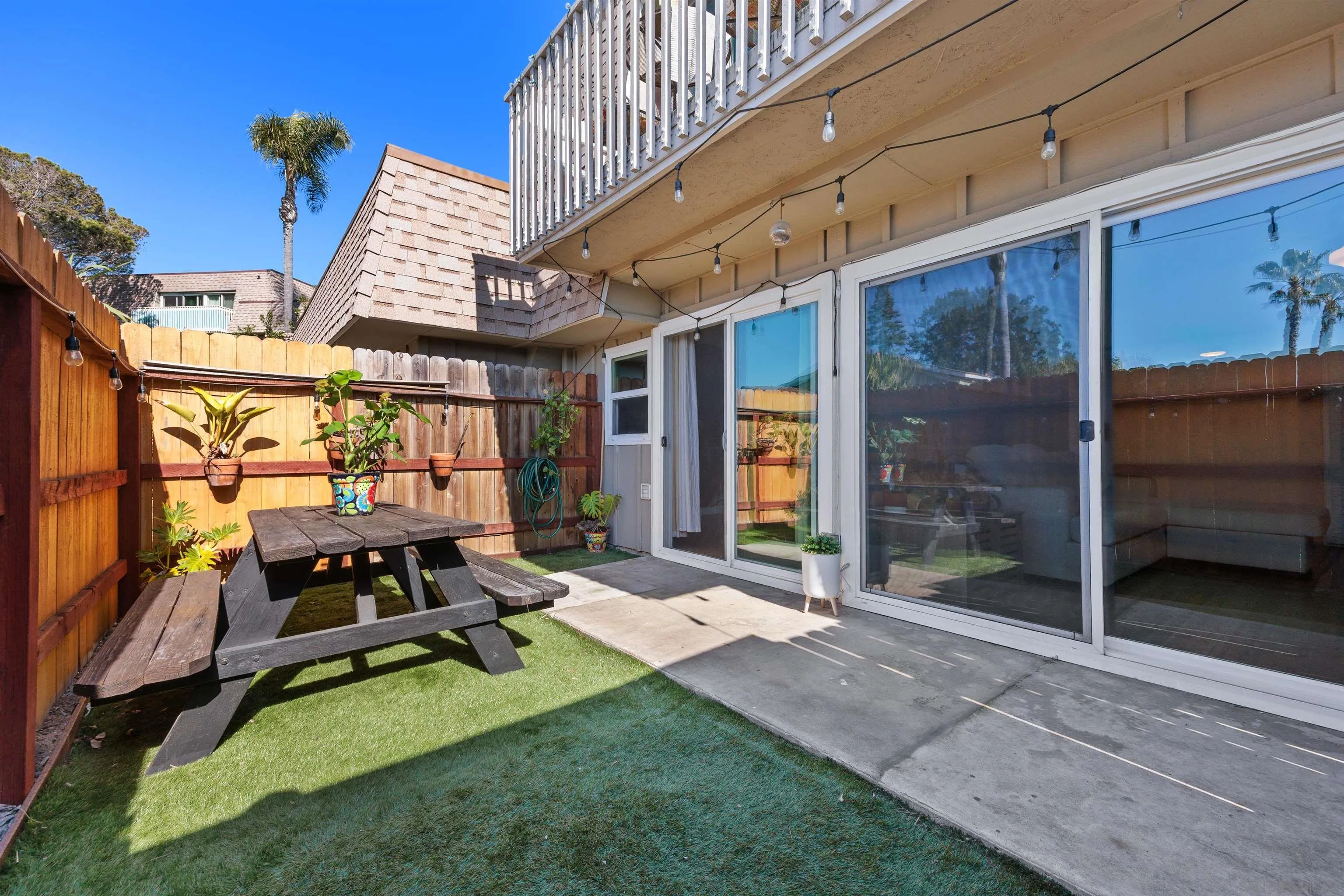 a view of a patio with a table and chairs and potted plants