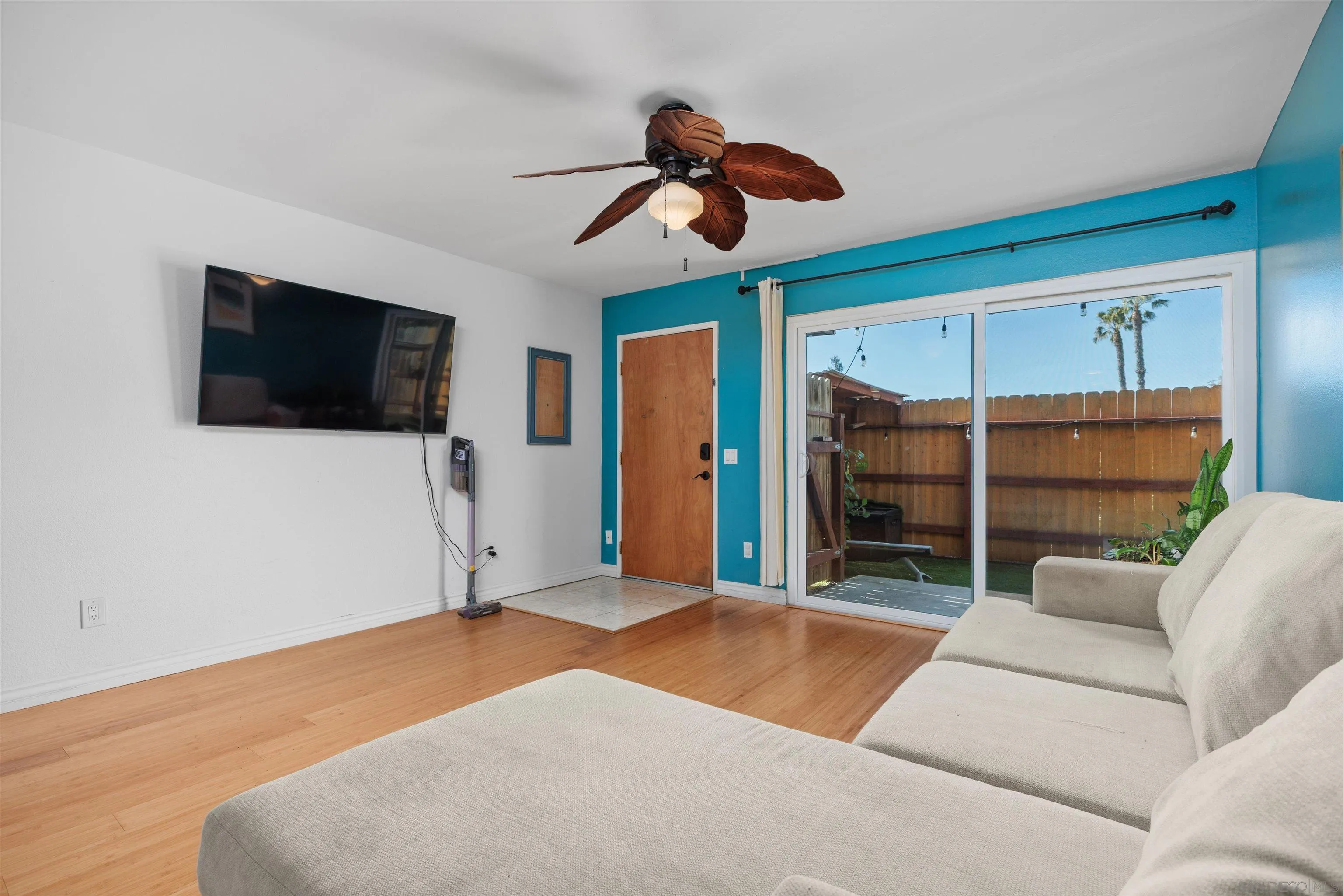 407 Requeza Street, Unit E9 Encinitas, CA 92024 - Photo 3 of 19 a living room with furniture and a flat screen tv