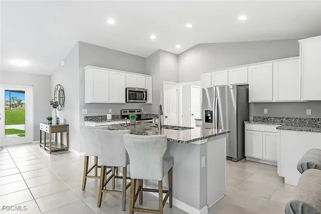 a kitchen with stainless steel appliances a refrigerator sink and stove