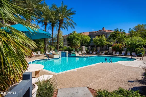 a view of a backyard with swimming pool