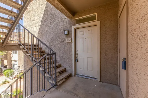 a view of entryway with wooden floor and stairs