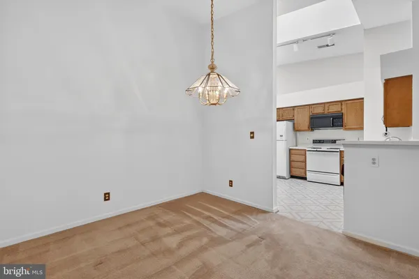 a view of a kitchen with a sink and a chandelier