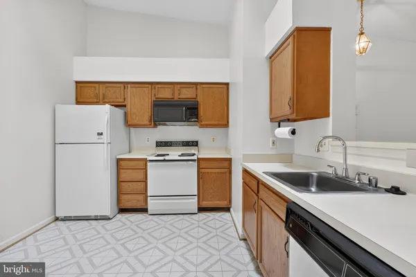 a kitchen with a sink cabinets and stainless steel appliances