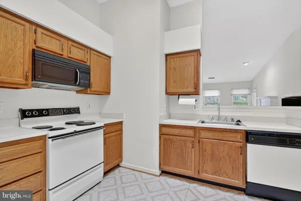 a kitchen with a sink stove and microwave