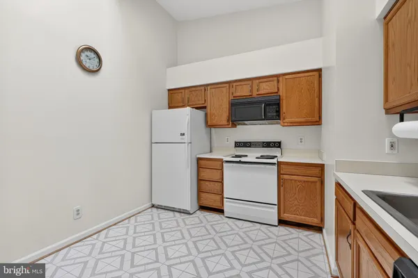 a kitchen with a stove top oven and cabinets