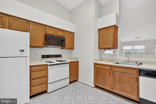 a kitchen with a sink stove and refrigerator