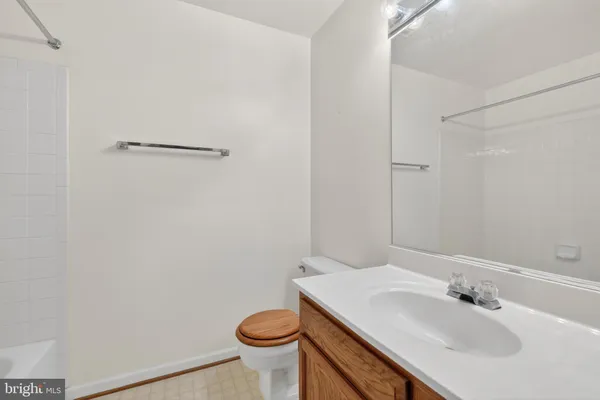 a living room with furniture and a lamp