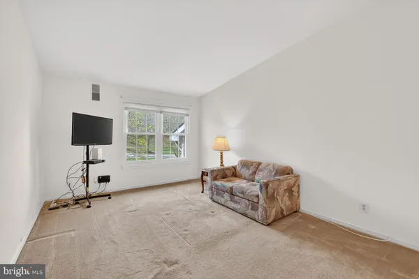 a living room with furniture and a lamp