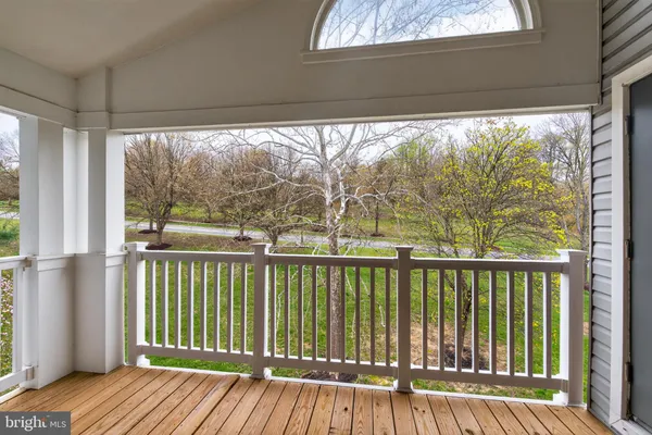 a view of a balcony with wooden floor