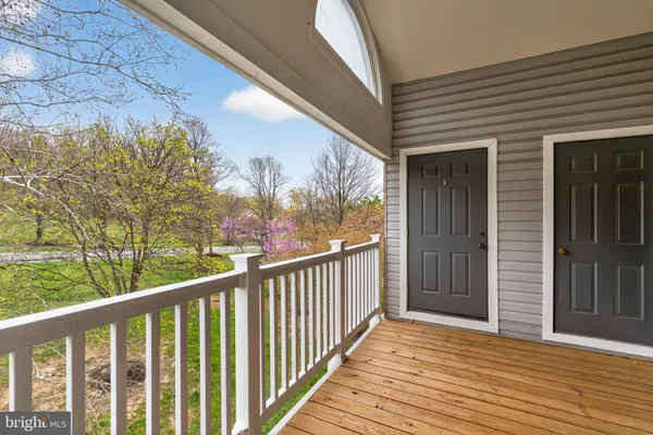 a view of a balcony with wooden floor