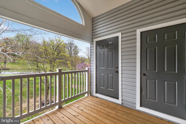 a view of a balcony with wooden floor