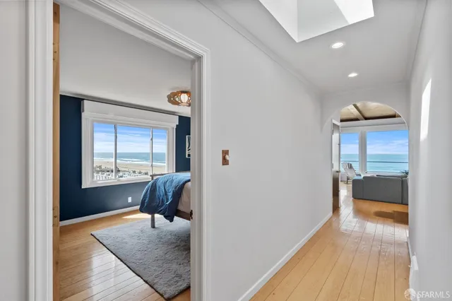 a living room with furniture and large windows