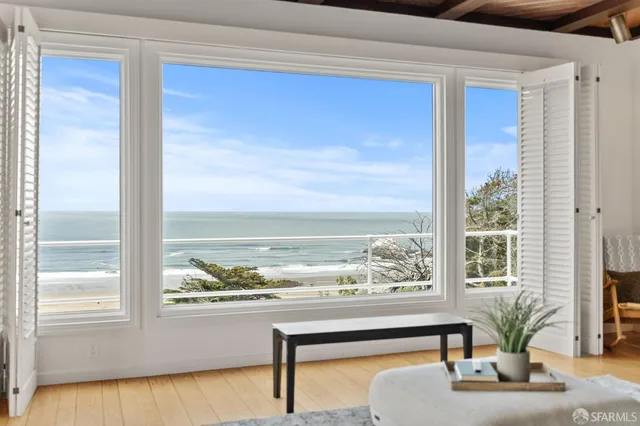 a bedroom with a bed and a large window with outer view