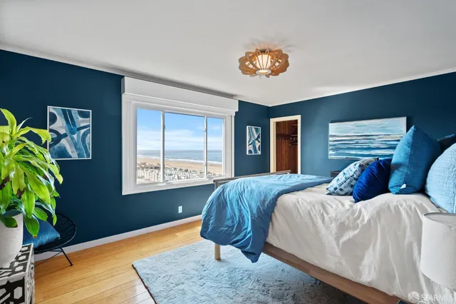 a bedroom with furniture and a flat screen tv