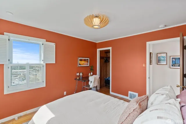 a bathroom with a toilet a sink a mirror a vanity and shower