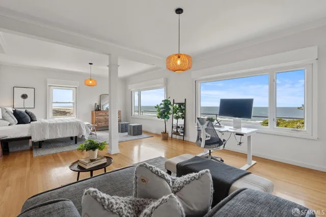 a view of an empty room with wooden floors