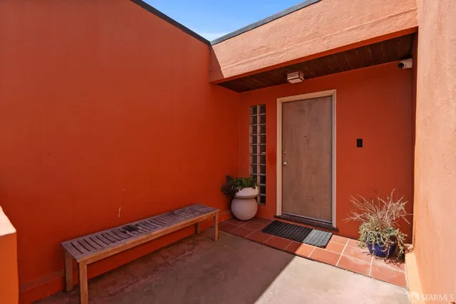 a living room with furniture wooden floor and a large window