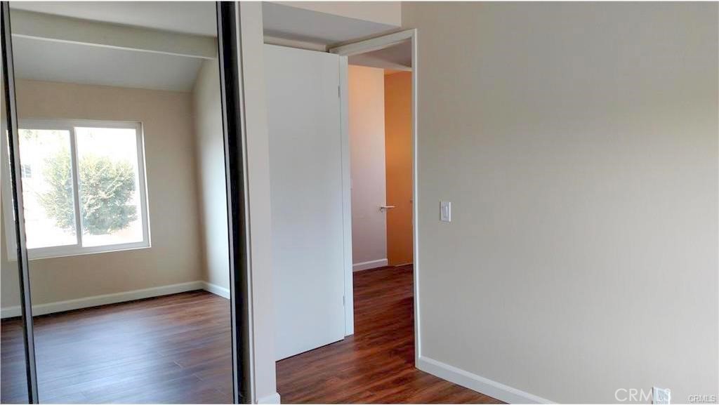 8 Sage Irvine, CA 92604 - Photo 13 of 32 a view of an empty room with wooden floor and a window