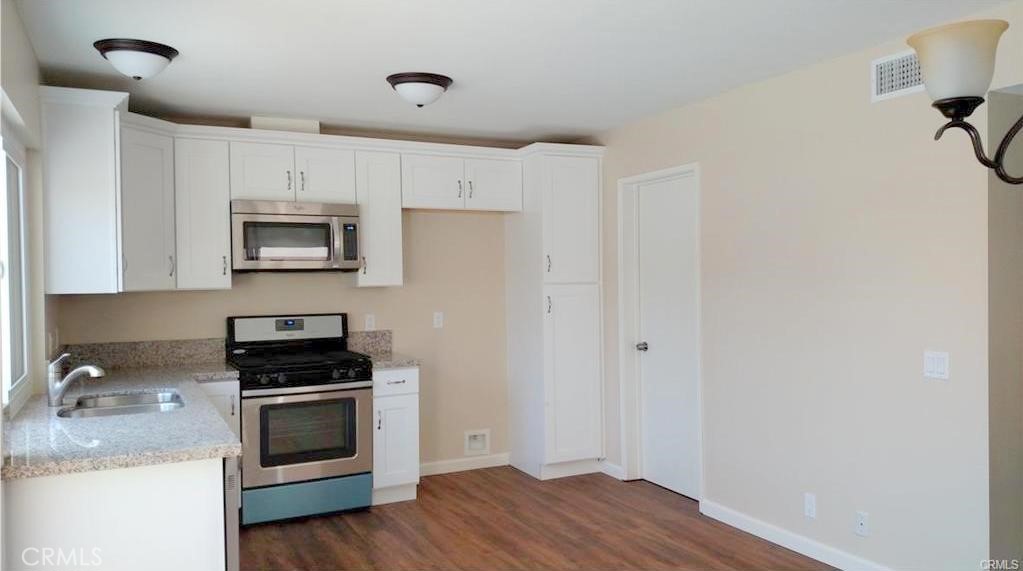 8 Sage Irvine, CA 92604 - Photo 4 of 32 a kitchen with sink a microwave and cabinets
